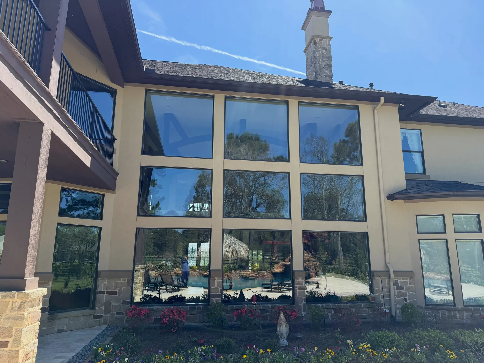 Two-story wall of freshly cleaned windows on a Cypress home